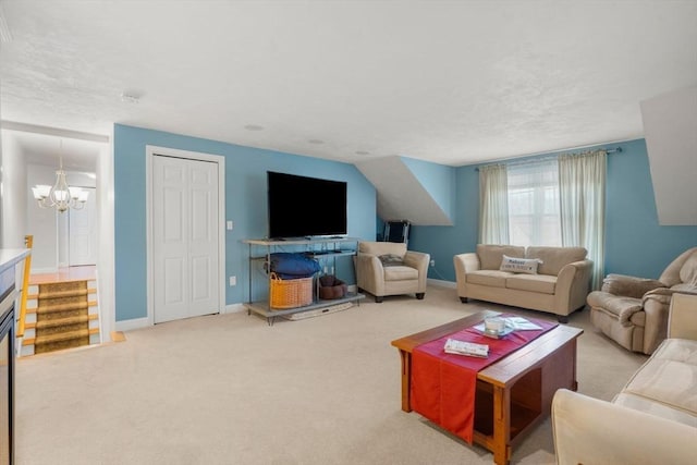 carpeted living room featuring a notable chandelier