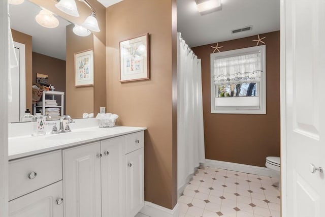 bathroom featuring vanity and toilet