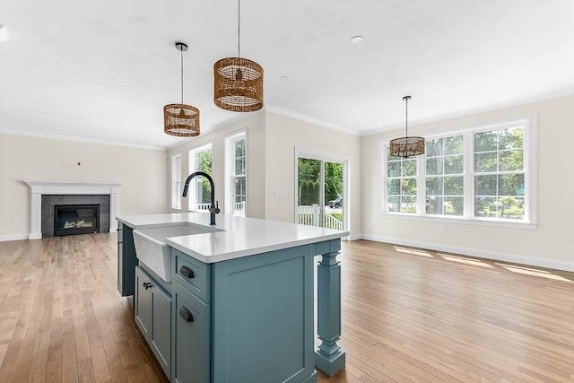 20 Sperry Ln, North Attleboro, MA 02760 - kitchen featuring open floor plan, a sink, light wood finished floors, light countertops, and crown molding