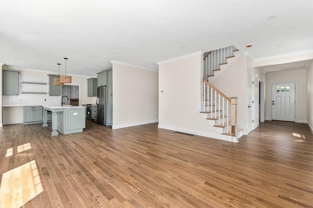 20 Sperry Ln, North Attleboro, MA 02760 - unfurnished living room featuring wood finished floors, stairway, crown molding, and baseboards