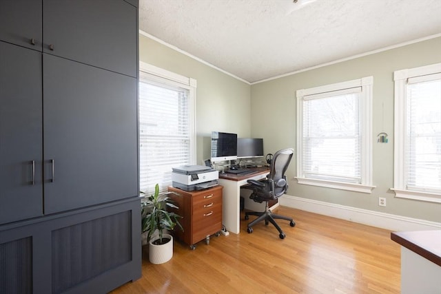 home office with baseboards, a textured ceiling, ornamental molding, and light wood finished floors