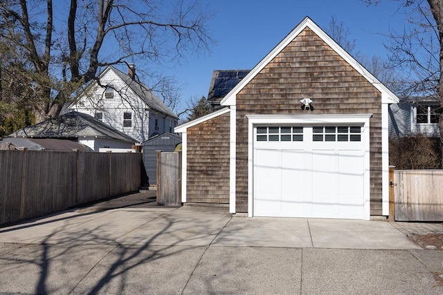 detached garage with driveway and fence