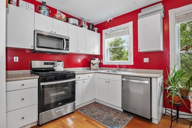 4 Marlou Unit 3, Boston, MA 02130 - kitchen featuring appliances with stainless steel finishes, a sink, white cabinets, and plenty of natural light