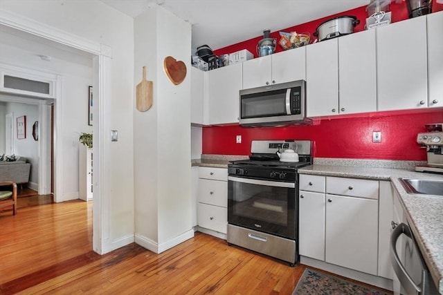 4 Marlou Unit 3, Boston, MA 02130 - kitchen with stainless steel appliances, light wood finished floors, white cabinetry, and baseboards