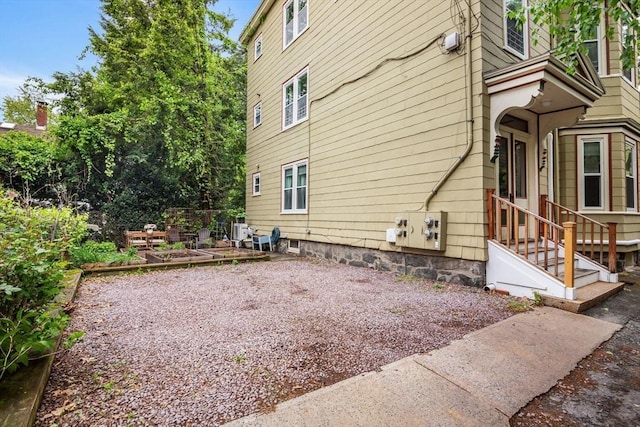 4 Marlou Unit 3, Boston, MA 02130 - view of side of property with a vegetable garden, cooling unit, and entry steps