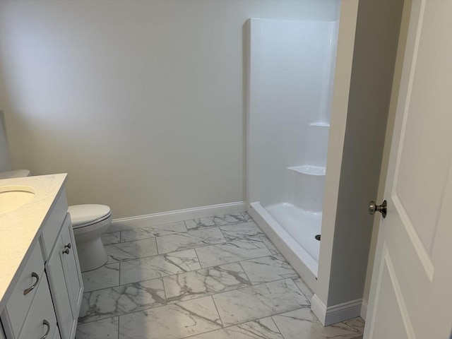 full bathroom featuring marble finish floor, a shower stall, vanity, and baseboards