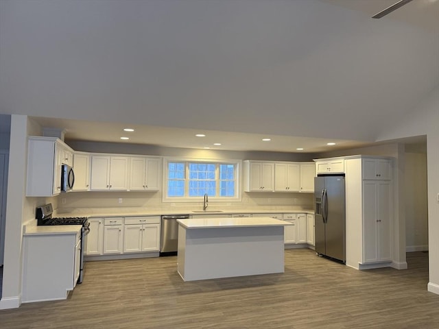 kitchen with white cabinets, appliances with stainless steel finishes, light countertops, and a sink