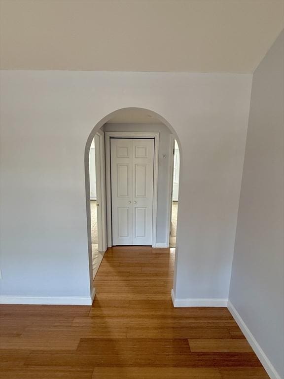 56 Center St Unit 2-3, Dennis, MA 02639 - corridor with arched walkways, wood finished floors, and baseboards