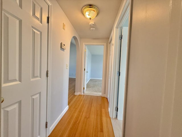 56 Center St Unit 2-3, Dennis, MA 02639 - corridor featuring arched walkways, light wood-style floors, and baseboards