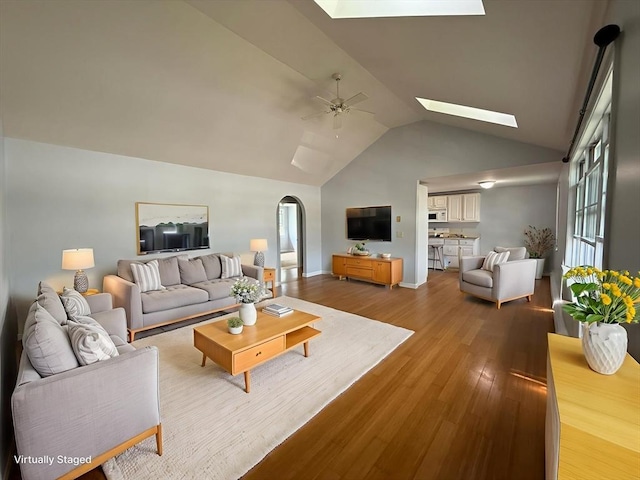 56 Center St Unit 2-3, Dennis, MA 02639 - living room with a skylight, a ceiling fan, wood finished floors, arched walkways, and high vaulted ceiling