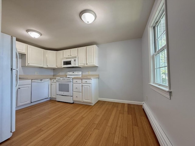 56 Center St Unit 2-3, Dennis, MA 02639 - kitchen featuring white appliances, light wood finished floors, light countertops, baseboards, and white cabinets