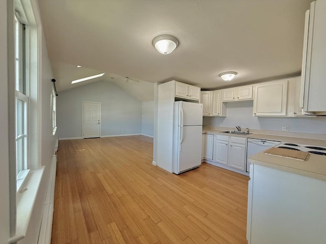 56 Center St Unit 2-3, Dennis, MA 02639 - kitchen featuring white appliances, a sink, light countertops, light wood-type flooring, and lofted ceiling