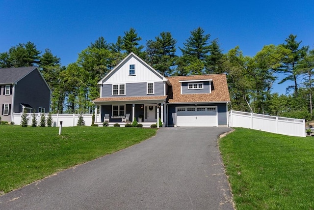 1838 Central St, East Bridgewater, MA 02333 - view of front of home featuring covered porch, driveway, a shingled roof, board and batten siding, and an attached garage