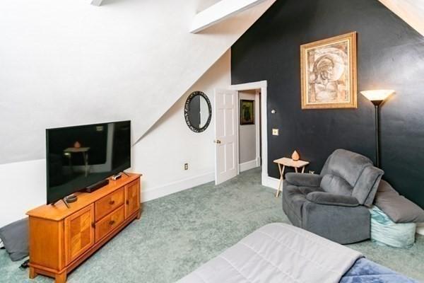 117 Church St Unit 4, North Attleboro, MA 02760 - living area with light colored carpet, baseboards, and lofted ceiling