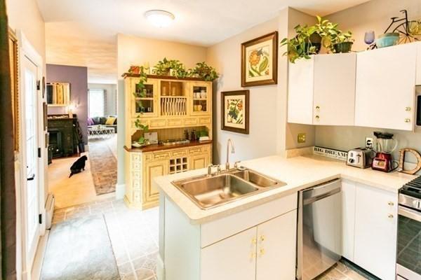 117 Church St Unit 4, North Attleboro, MA 02760 - kitchen with a peninsula, light countertops, white cabinets, a sink, and appliances with stainless steel finishes