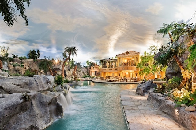 pool at dusk with pool water feature