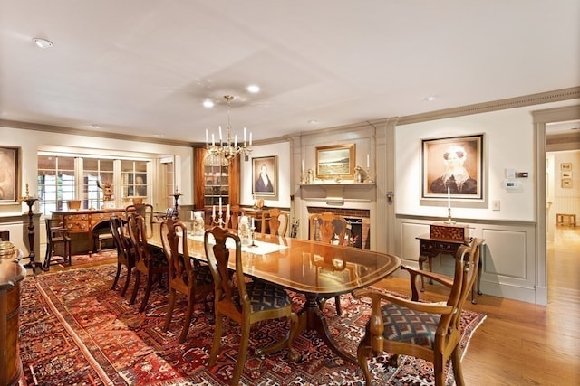 dining room featuring ornamental molding, a notable chandelier, and dark wood-type flooring