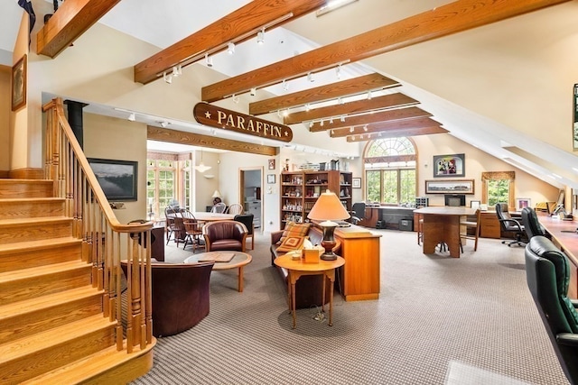 interior space featuring vaulted ceiling with beams, rail lighting, and carpet floors