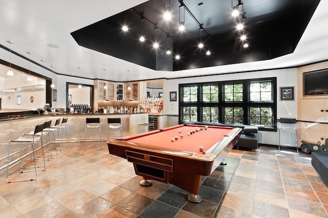 recreation room with a tray ceiling, rail lighting, light tile flooring, and pool table