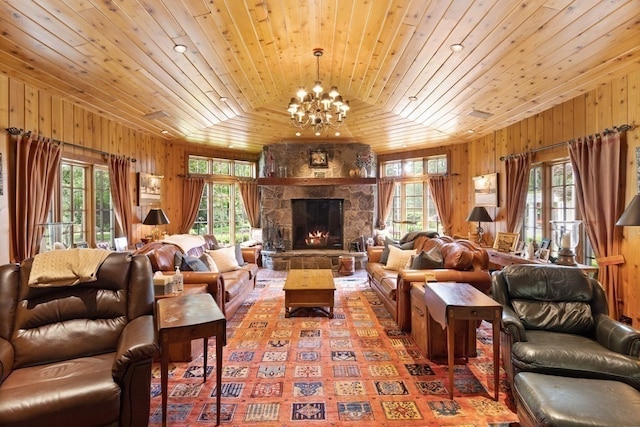 living room with wooden ceiling, a fireplace, a chandelier, and wooden walls