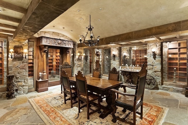 wine cellar featuring beam ceiling, light tile flooring, and a notable chandelier