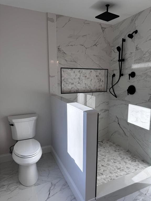 bathroom featuring toilet and tiled shower