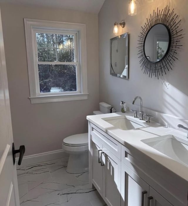 bathroom featuring vanity and toilet