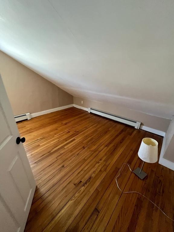 interior space with hardwood / wood-style flooring and baseboard heating