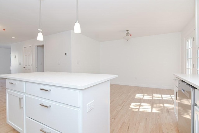 kitchen featuring white cabinetry, light countertops, light wood-style floors, dishwasher, and a center island