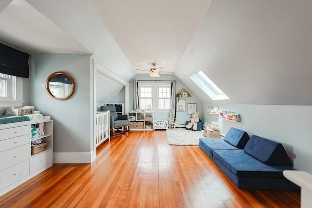 30 Crystal Cove Ave Unit 2, Winthrop, MA 02152 - living room featuring a skylight, light wood finished floors, a ceiling fan, lofted ceiling, and baseboards