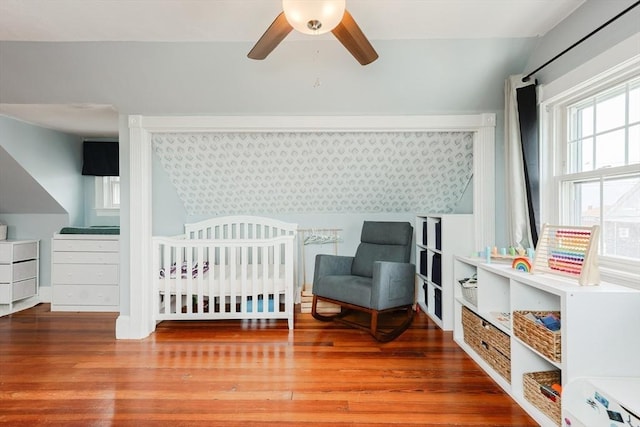 30 Crystal Cove Ave Unit 2, Winthrop, MA 02152 - bedroom featuring wood finished floors, a crib, and vaulted ceiling