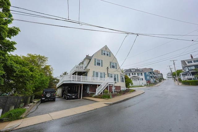 30 Crystal Cove Ave Unit 2, Winthrop, MA 02152 - view of front of home featuring driveway, stairs, and a wooden deck