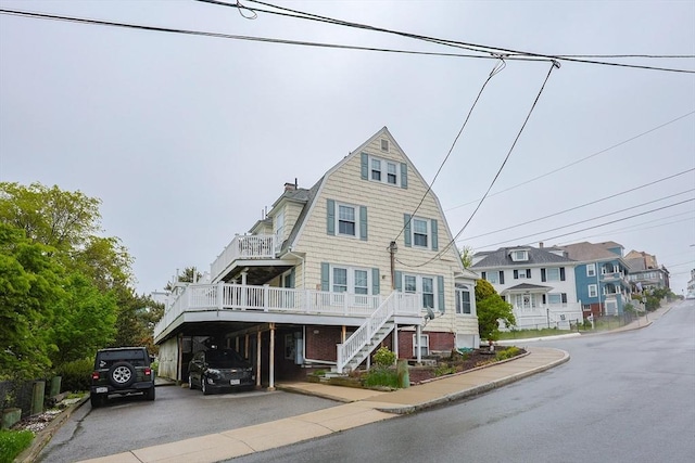 30 Crystal Cove Ave Unit 2, Winthrop, MA 02152 - view of front facade featuring a gambrel roof, stairs, driveway, a carport, and a chimney