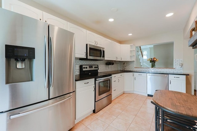 30 Crystal Cove Ave Unit 2, Winthrop, MA 02152 - kitchen featuring appliances with stainless steel finishes, a sink, dark countertops, open shelves, and white cabinetry