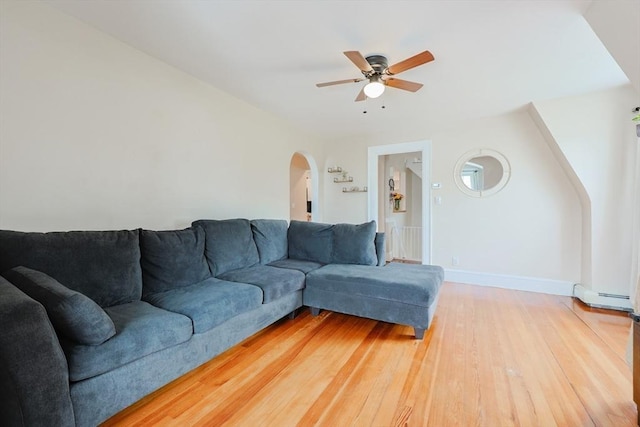 30 Crystal Cove Ave Unit 2, Winthrop, MA 02152 - living area with arched walkways, ceiling fan, light wood-style flooring, a baseboard heating unit, and baseboards