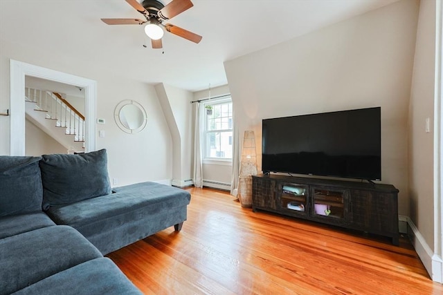 30 Crystal Cove Ave Unit 2, Winthrop, MA 02152 - living room featuring light wood finished floors, stairway, a ceiling fan, a baseboard heating unit, and baseboards