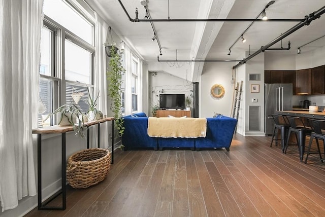 living room featuring track lighting and dark hardwood / wood-style flooring