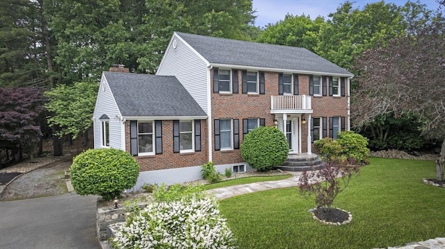 5 Ledgewood Rd, Saugus, MA 01906 - view of front facade featuring a chimney, a front lawn, brick siding, and roof with shingles