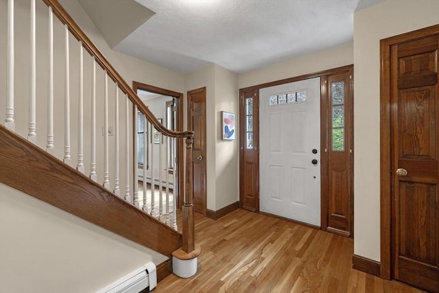5 Ledgewood Rd, Saugus, MA 01906 - entrance foyer with light wood-style floors, a baseboard radiator, and stairs
