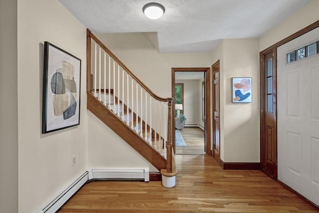 5 Ledgewood Rd, Saugus, MA 01906 - entrance foyer with light wood-style floors, stairway, baseboard heating, and a textured ceiling
