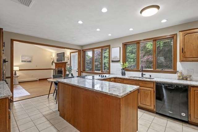5 Ledgewood Rd, Saugus, MA 01906 - kitchen featuring black appliances, light tile patterned flooring, a brick fireplace, light stone countertops, and recessed lighting