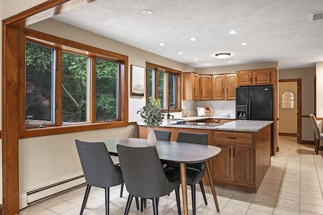 5 Ledgewood Rd, Saugus, MA 01906 - kitchen featuring a baseboard heating unit, black appliances, brown cabinetry, a peninsula, and light tile patterned floors