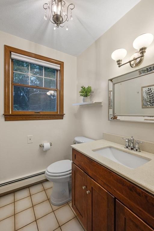 5 Ledgewood Rd, Saugus, MA 01906 - bathroom with vanity, a baseboard heating unit, and tile patterned floors