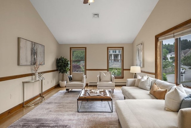 5 Ledgewood Rd, Saugus, MA 01906 - living area featuring plenty of natural light, wood finished floors, a baseboard heating unit, a ceiling fan, and high vaulted ceiling