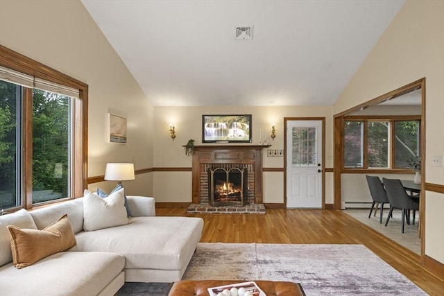 5 Ledgewood Rd, Saugus, MA 01906 - living room featuring wood finished floors, a fireplace, high vaulted ceiling, and baseboard heating