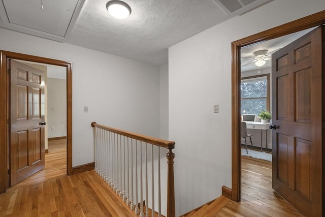 5 Ledgewood Rd, Saugus, MA 01906 - hallway with an upstairs landing, light wood-type flooring, and a textured ceiling