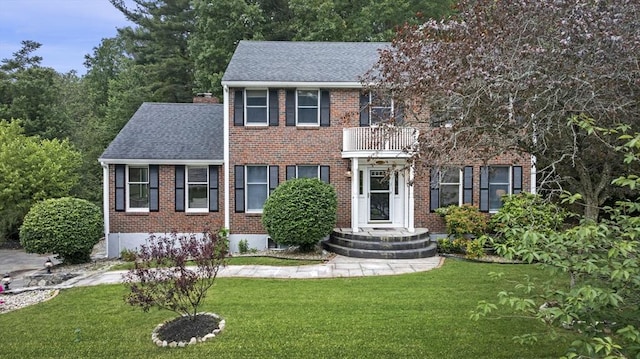5 Ledgewood Rd, Saugus, MA 01906 - view of front of home featuring brick siding, a balcony, roof with shingles, and a front yard