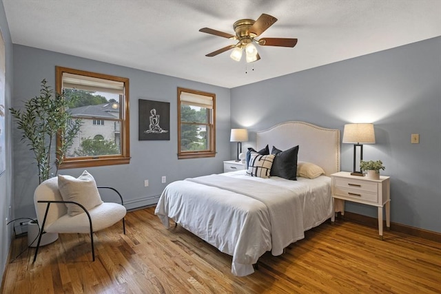 5 Ledgewood Rd, Saugus, MA 01906 - bedroom featuring wood finished floors, multiple windows, ceiling fan, and a baseboard radiator