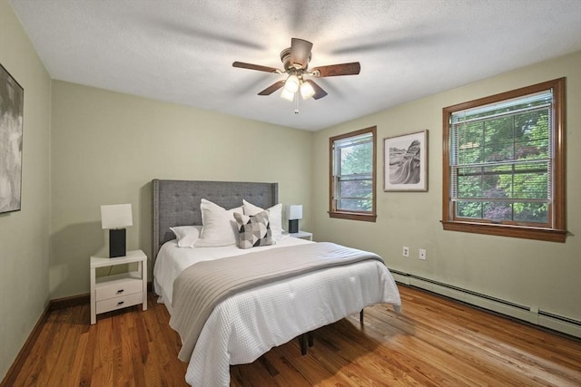 5 Ledgewood Rd, Saugus, MA 01906 - bedroom featuring wood finished floors, a baseboard heating unit, and a ceiling fan