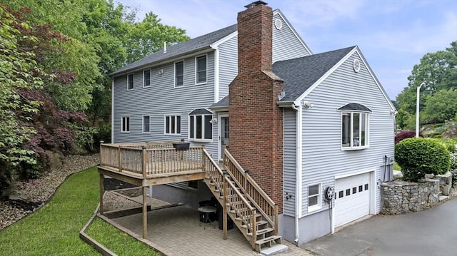 5 Ledgewood Rd, Saugus, MA 01906 - back of property featuring a chimney, an attached garage, a wooden deck, stairs, and roof with shingles